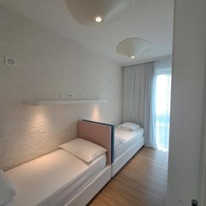 two beds in a room with a window at Marina Verde Resort Official in Caorle +63 photos