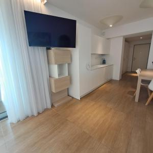 a living room with a flat screen tv on the wall at Marina Verde Resort Official in Caorle