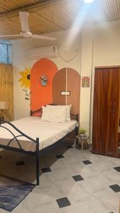a bedroom with a large bed in a room at Drona Farms in Bhundsi