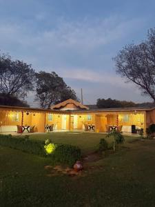a large building with lights in front of it at Drona Farms in Bhundsi