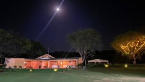 a house at night with a lighted at Drona Farms in Bhundsi +4 photos
