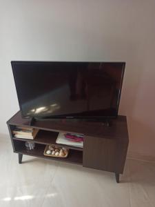 a flat screen tv sitting on a entertainment center at Magenta in Igoumenitsa