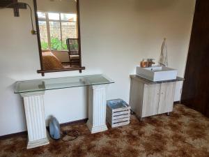 a bathroom with a sink and a mirror at Highway Haven in Stilfontein