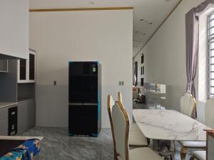 a kitchen and dining room with a table and chairs at MAY homestay in Phú Khương +15 photos