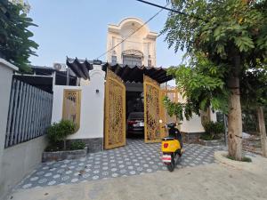 a yellow scooter parked in front of a building at MAY homestay in Phú Khương