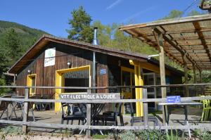 a building with tables in front of it at Chanteduc in Beaurières