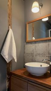 a bathroom with a white sink and a mirror at La vie en rose in Brinay