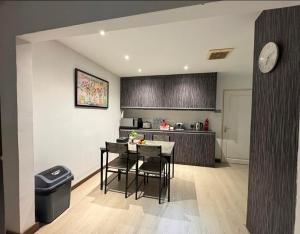 a kitchen with a table and chairs in a room at Aika Homestay in Shah Alam +14 photos