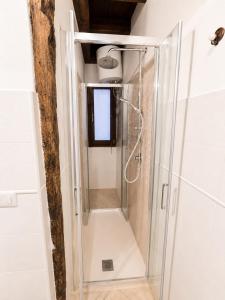 a shower with a glass door in a bathroom at L'Antica Torre Caralis Holiday in Cagliari +91 photos