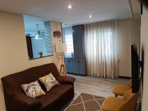 a living room with a couch and a television at Apartamento céntrico Irene IV in Avilés