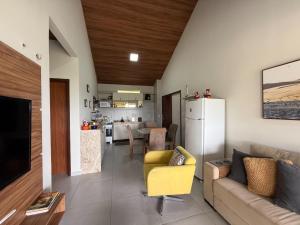 a living room with a couch and a kitchen at dreams of the mountains in Bananeiras