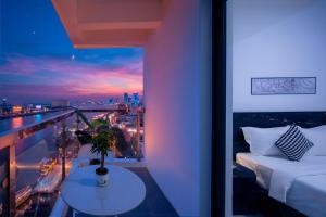 a room with a bed and a view of a city at Mecon Hotel in Phnom Penh +86 photos