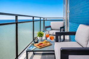 a balcony with a tray of food on a table at You and the Sea in Savona