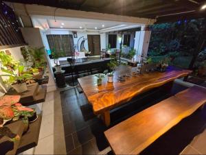 a large wooden table in a room with benches at Aika Homestay in Shah Alam
