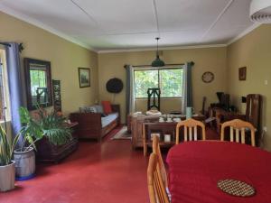 a living room with a red table and chairs at Mary House in Arusha