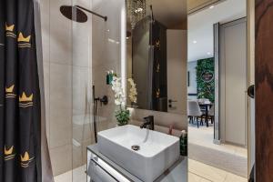 a bathroom with a sink and a shower at KRUNA 406 Luxury Sea View Apartment with Parking, Minibar, Spa & Beach - Includes 2 Complimentary Non-Alcoholic Beach Drinks & Welcome Gift in Budva