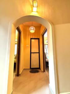 an entrance to a hallway with a black door at Seven Summers - Mandrem in Mandrem