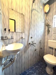 a bathroom with a sink and a toilet at Seven Summers - Mandrem in Mandrem +5 photos