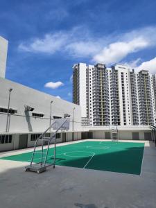 a tennis court in front of a building with tall buildings at RAF Homestay Seri Serindit in Malacca
