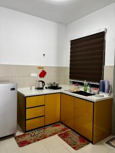 a kitchen with a sink and a refrigerator at RAF Homestay Seri Serindit in Malacca