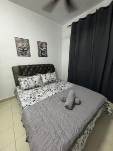 a bed in a bedroom with black curtains at RAF Homestay Seri Serindit in Malacca +14 photos