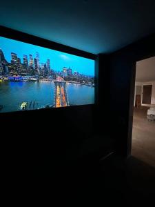 a flat screen tv in a room with a view of a city at Villa Terra Akal in Essaouira
