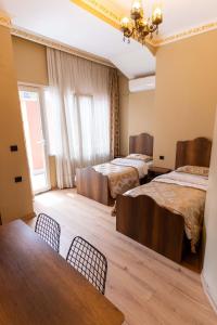 a room with two beds and a table and chairs at The Old Ottoman Castle in Istanbul