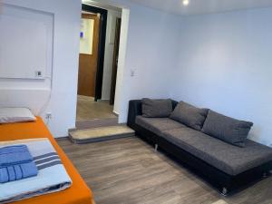 a living room with a couch and a table at Seven’S Apartments in Löhnberg