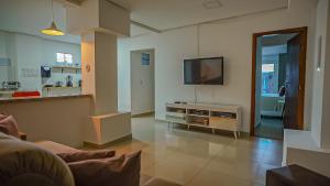 a living room with a flat screen tv on a wall at Vila Fox Estadia in Lençóis