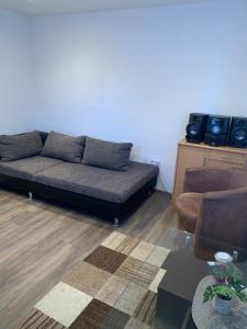 a living room with a couch and a table at Seven’S Apartments in Löhnberg