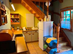 a kitchen with a white refrigerator and a staircase at Anglo-Polish Holidays in Chycina +26 photos