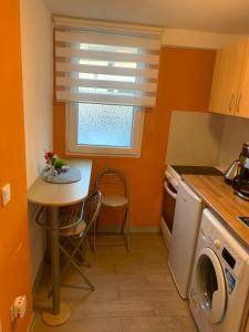 a small kitchen with a table and a window at Seven’S Apartments in Löhnberg