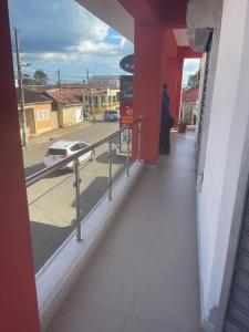 a person sitting on a balcony with a view of a street at Plata View Center Habitacion 2D in Monte Plata