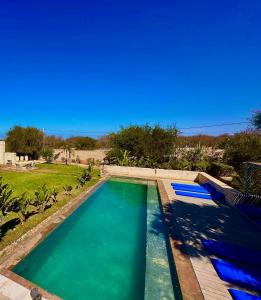 a swimming pool in a yard with a blue sky at Villa Terra Akal in Essaouira