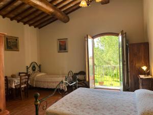 a bedroom with two beds and an open door at Agriturismo IL VIAIO in Fiesole +110 photos