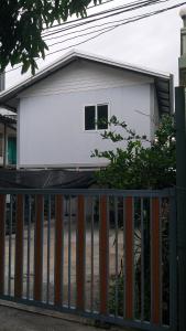 a house with a fence in front of it at 50 m by BTS Taladplu in Thonhuri