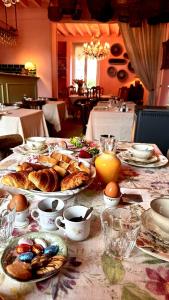 a table with plates of pastries and eggs on it at La vie en rose in Brinay +40 photos