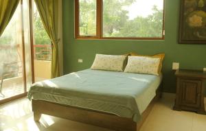 a bedroom with a bed in a room with a window at Y Van Cac Homestay Ninh Binh Art Heritage Rice Field in Ninh Binh