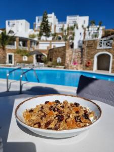 a plate of food on a table next to a pool at Hotel Katerina in Mylopotas
