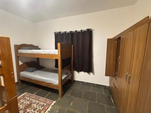 a room with two bunk beds and a window at Casa com alojamento, para até 19 pessoas in Itu