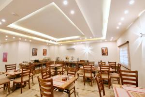 a dining room with wooden tables and chairs at Petra Premium Inn in Wadi Musa