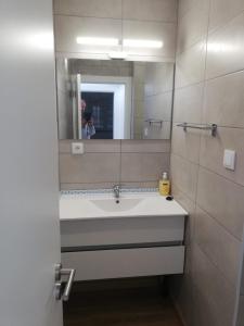 a bathroom with a sink and a mirror at Atalaia Garden House in Giz +15 photos