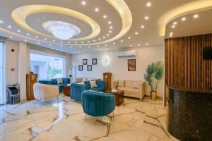a lobby with blue chairs and a large ceiling at Petra Premium Inn in Wadi Musa