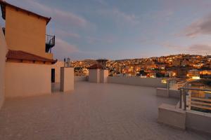 a rooftop view of a city at night at Petra Premium Inn in Wadi Musa