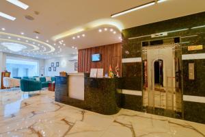 a lobby of a hotel with a bar in the middle at Petra Premium Inn in Wadi Musa