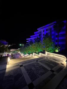 a night view of a building with blue lights at Pool View Private Apartment in Vlorë