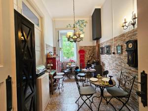 a kitchen with tables and chairs in a room at alojamento maritimo II in Espinho