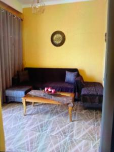 a living room with a couch and a coffee table at VILLA MAKRI 2 in Makri