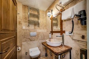 a bathroom with a sink and a toilet at Rocca Stone House in Göreme +67 photos