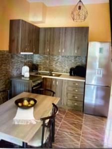a kitchen with a table with a bowl of fruit on it at VILLA MAKRI 2 in Makri